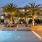 a pool with chairs and palm trees