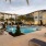 a pool in a courtyard with palm trees in the background