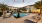 a pool in a courtyard with palm trees in the background