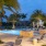 a pool with chairs and palm trees