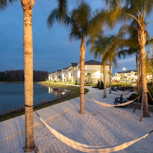 Settle into comfort at Pier 8 at The Preserve hammocks hanging on palm trees