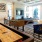 large, well lit game room with billiards and wall mounted tv